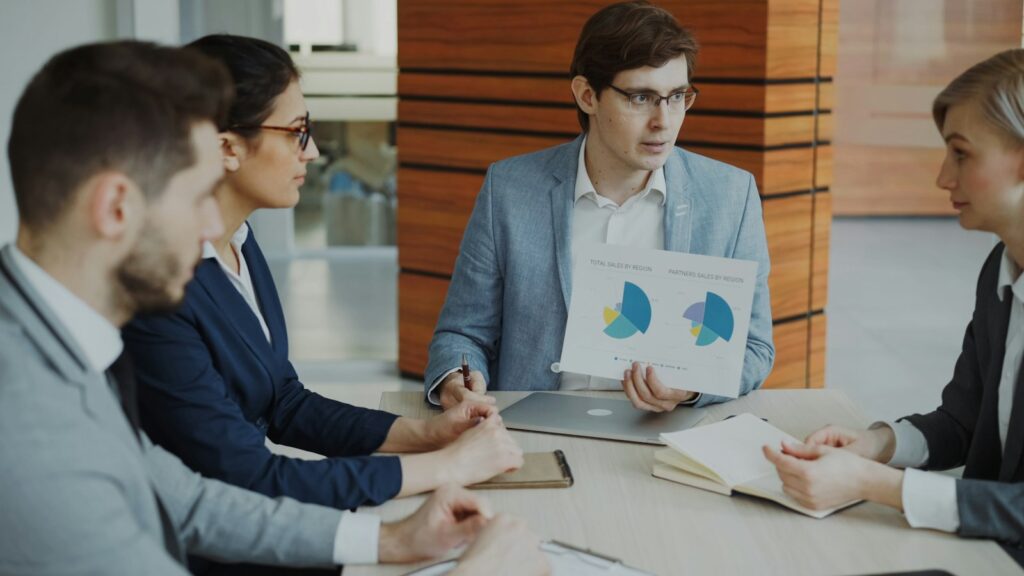 Team reviewing investment performance charts during a strategy meeting